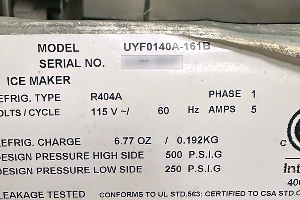 Data plate reading model UYF0140A-161B, refrigerant R404A, 115 volts, 6.77 ounce charge, 500 PSIG high side design pressure