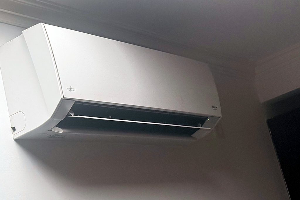 Wall mounted Fujitsu ductless indoor head in a residential room