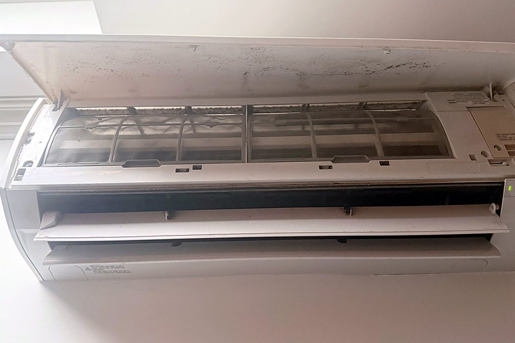 Fujitsu indoor head opened up showing the filters, blower wheel and coil behind them