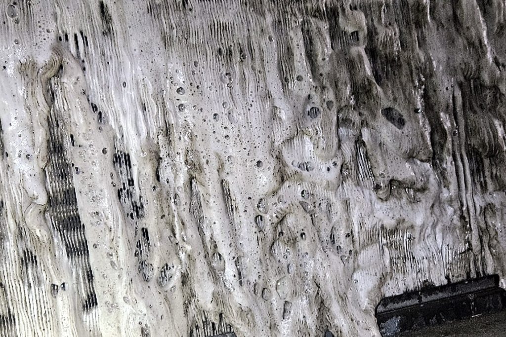 Walk-in cooler evaporator completely covered in a thick sheet of ice and frost