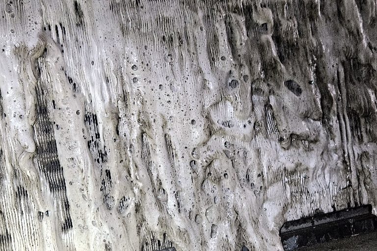 Walk-in cooler evaporator completely covered in a thick sheet of ice and frost