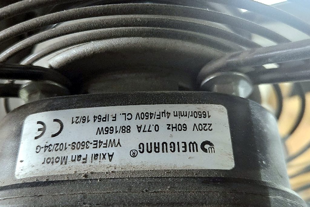 Label on a Weiguang axial fan motor reading YWF4E-500S, 220 volts, 60 hertz, 0.77 amps