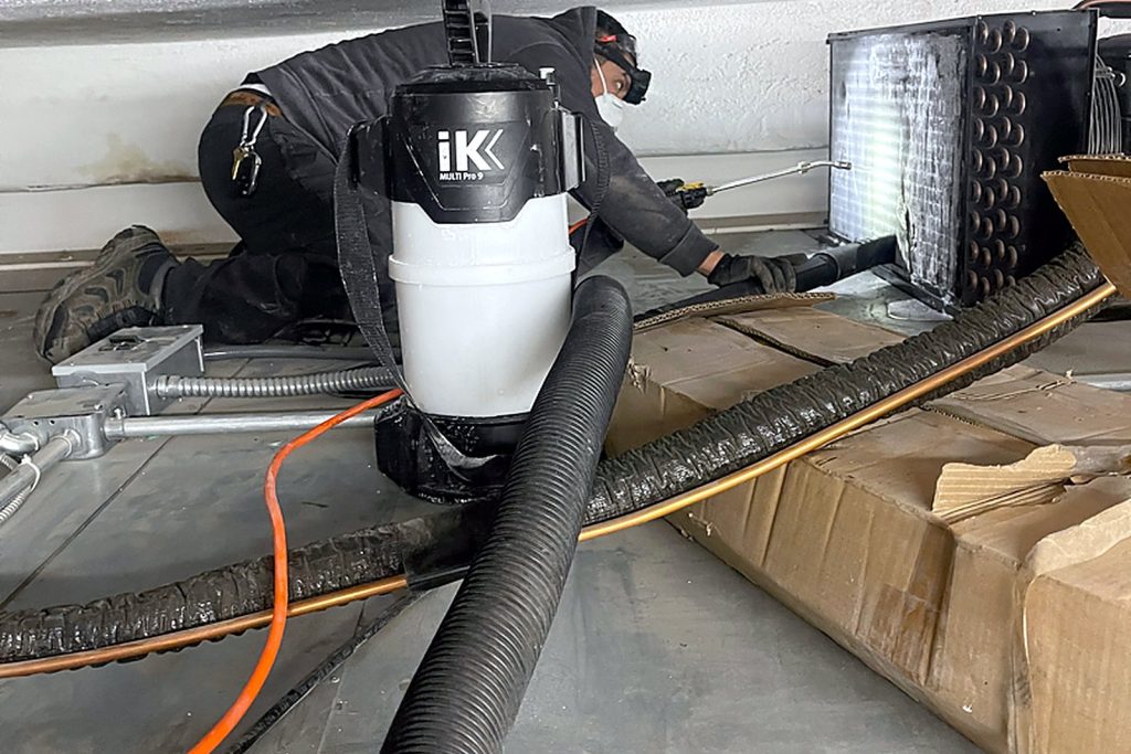 Recovery equipment and hoses set up beside the walk-in during system recovery and recharge