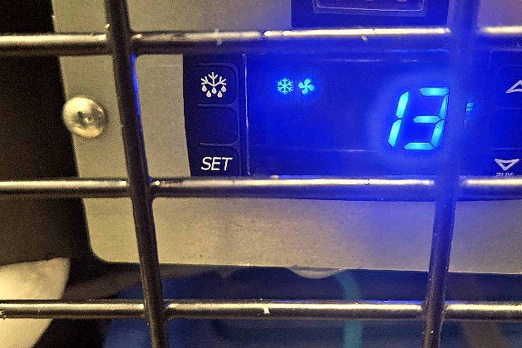 Blue LED refrigeration controller on the front of a walk-in reading 13 while the box is not holding temperature