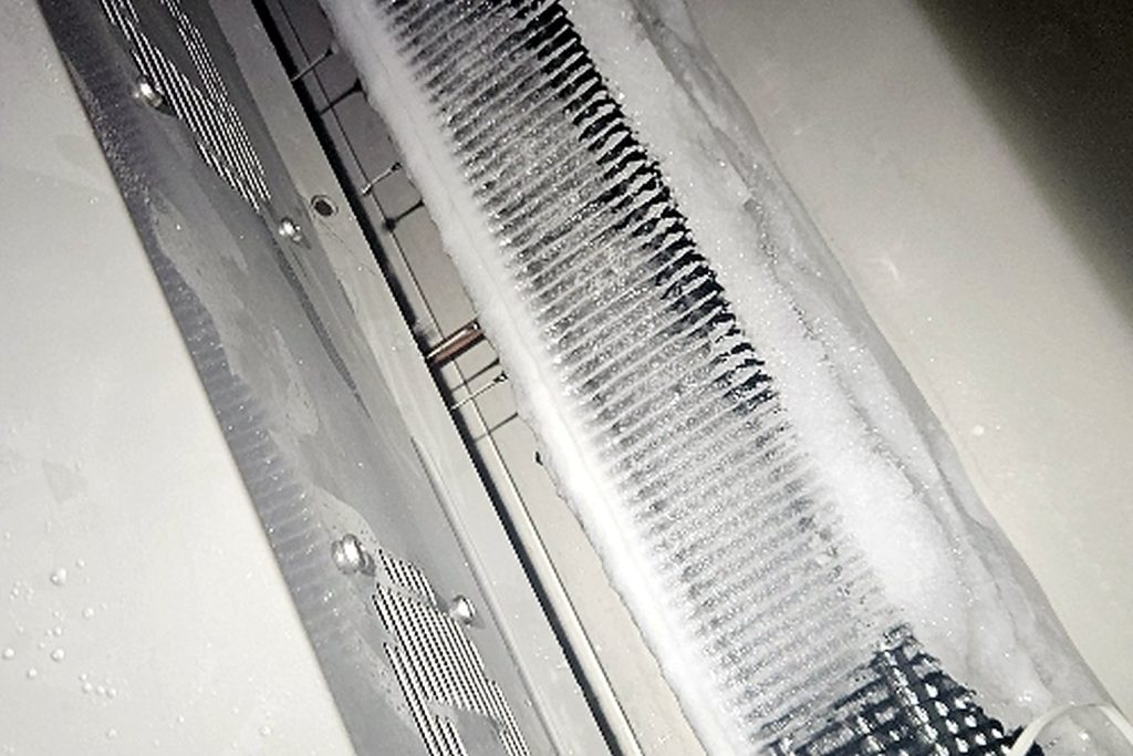 Walk-in evaporator coil checked through a full defrost cycle after the temperature control was replaced