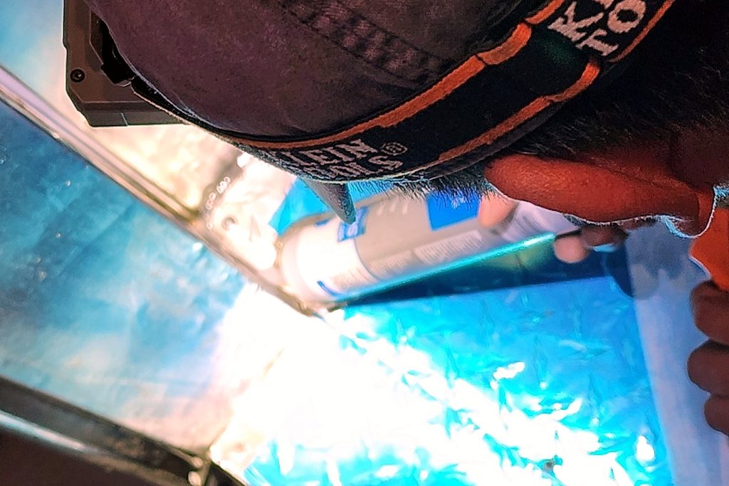 Bright welding arc as a technician seals a seam in the walk-in freezer floor deck