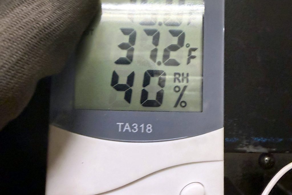 Product zone on our own thermo-hygrometer: 37.2°F and 40% relative humidity, measured inside the box rather than read off the door.