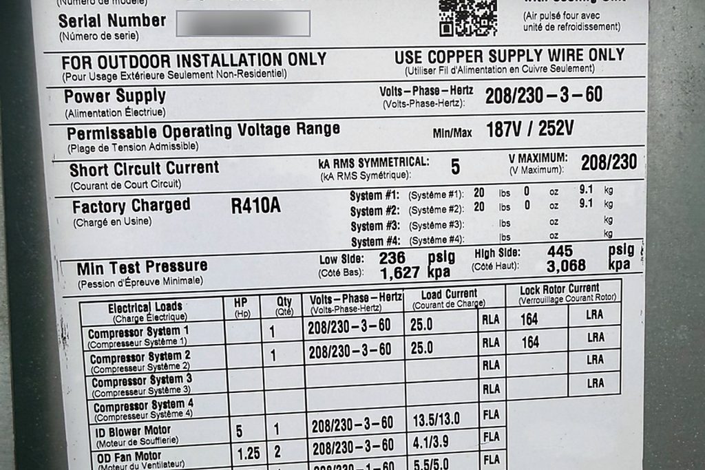 The rooftop unit plate: 208/230 V three phase, two compressors at 25.0 A running and 164 A locked rotor, two R-410A circuits factory charged at 20 lb each, a 5 HP indoor blower and two 1.25 HP outdoor fan motors.